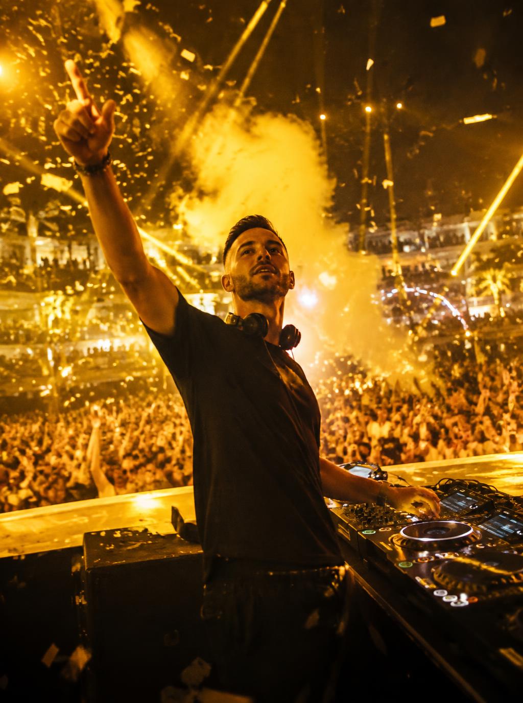 DJ, show host and dancers performing for an energetic crowd